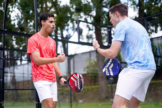 Two men in sports clothing playing padel tennis with Tecnifibre rackets.