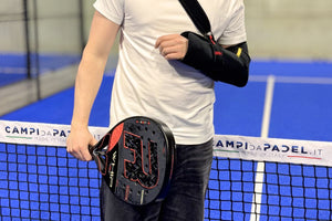 image of a man with his arm in a sling on a padel court