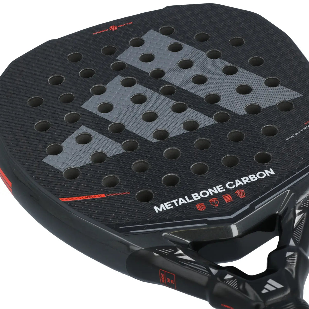 The face of a black Adidas Metalbone 2026 padel racket with orange detailing on a white background.