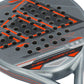 Close up of a black, orange and grey Adidas padel racket on a white background.