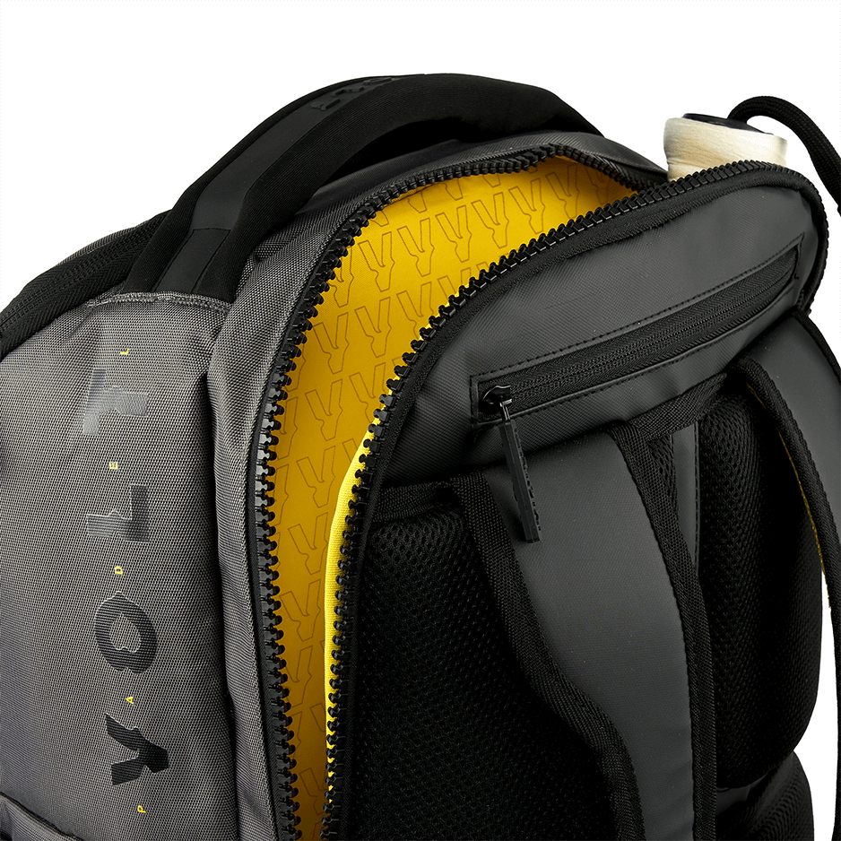 Grey Volt backpack with yellow interior and visible brand logo on a white background