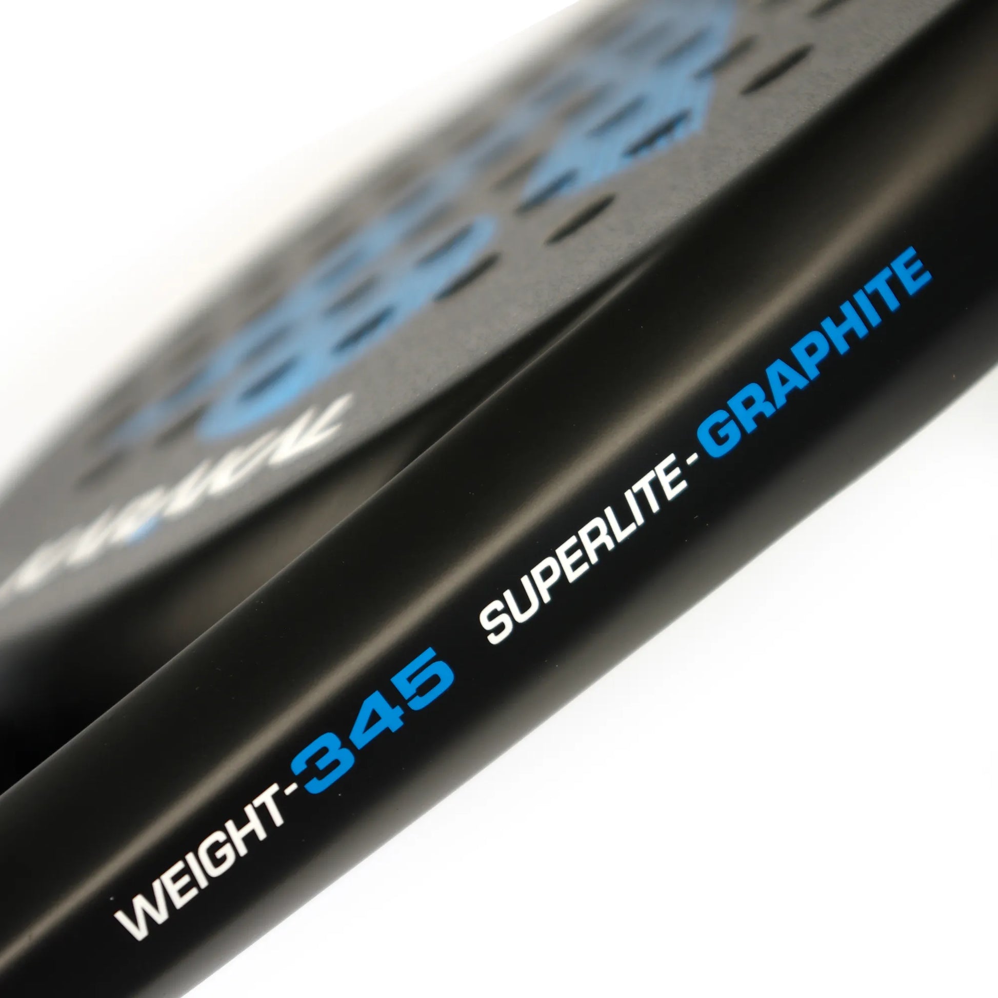 Close up of the side of a black and blue Karakal padel tennis racket on a white background.