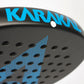 Close up of the top of a black and blue Karakal padel tennis racket on a white background.