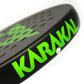 Close up of a black and green Karakal padel tennis racket on a white background.