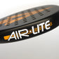 Close up of the side of a black and orange Karakal padel tennis racket on a white background.