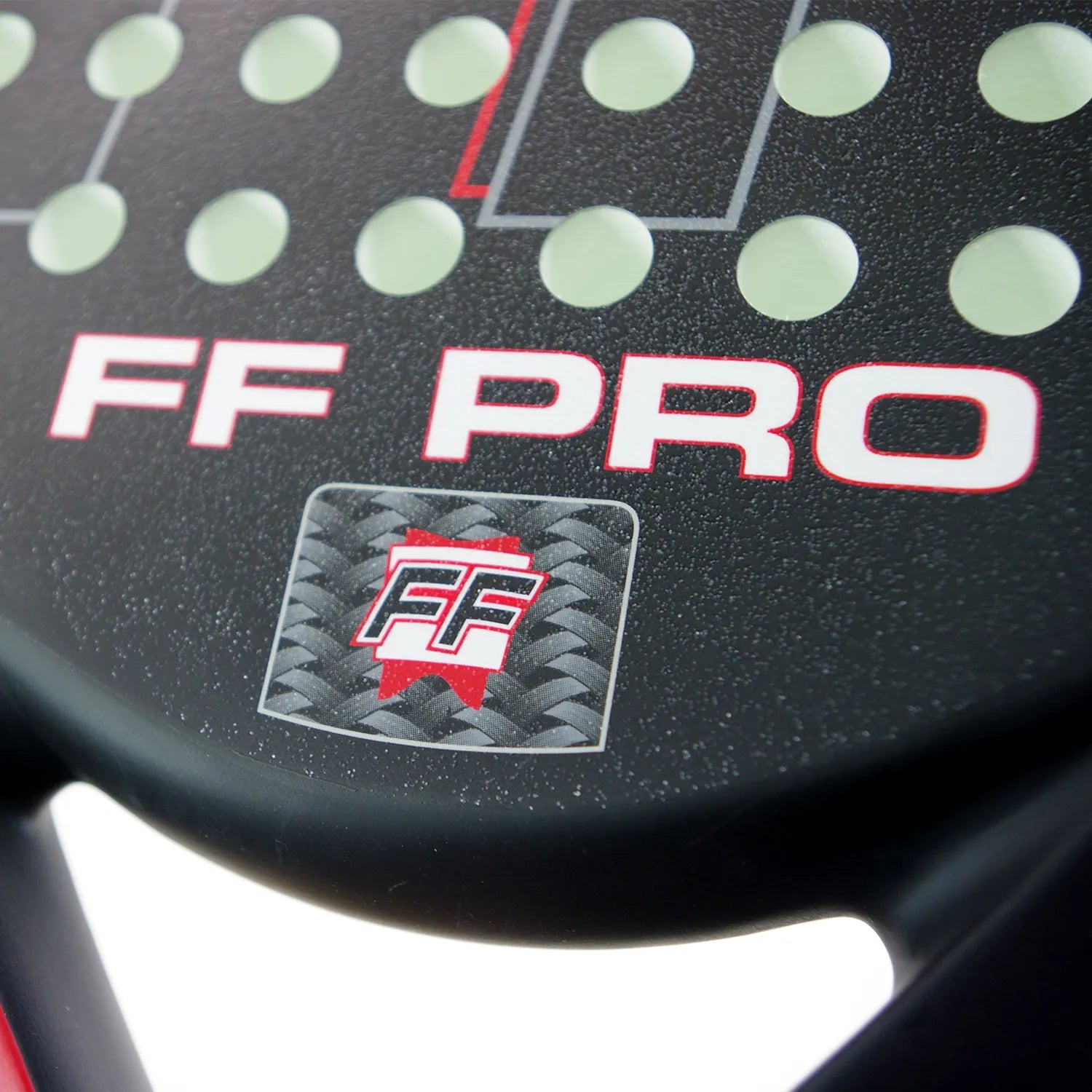 Close up of a black and red Karakal padel tennis racket on a white background.