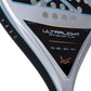 Close up of a grey Nox padel racket with black and blue branding on a white background.