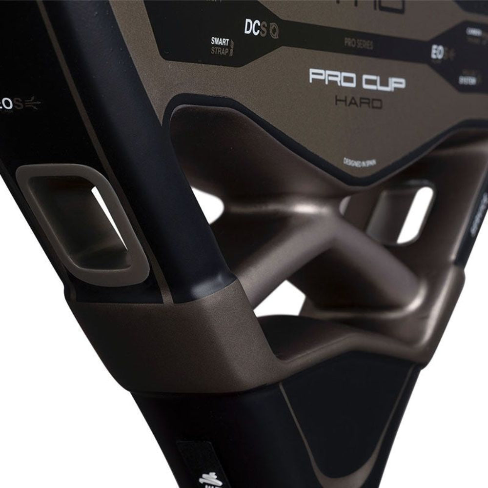 Close up of a black and copper Nox padel tennis racket on a white background.