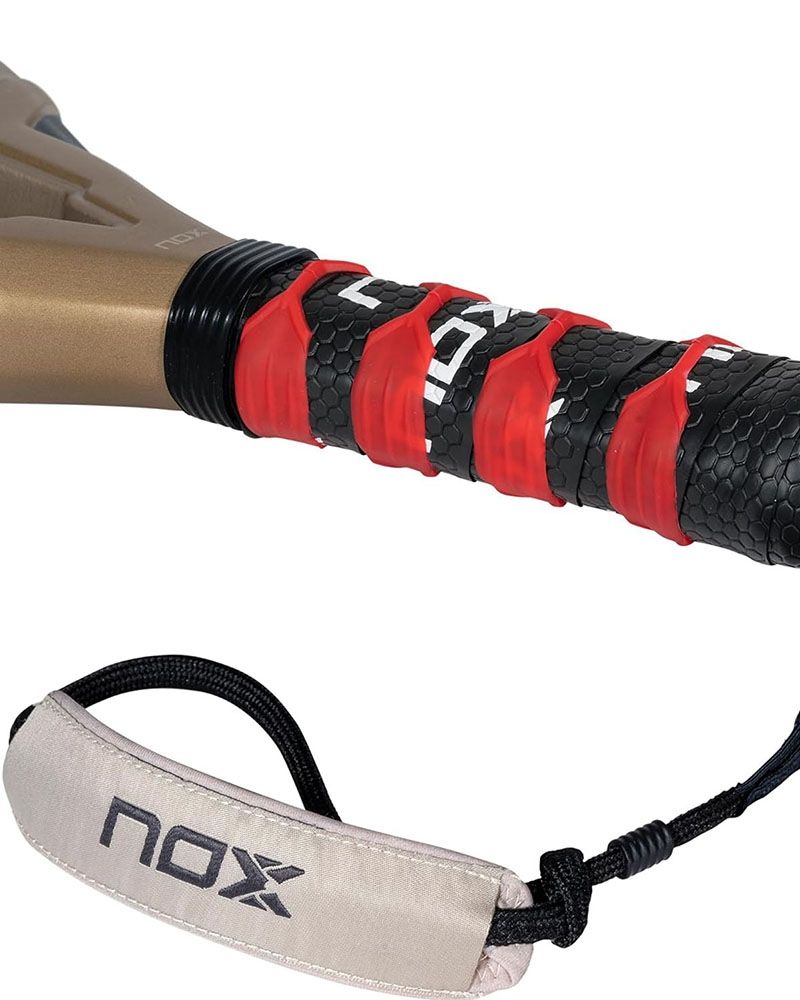 The handle of a gold Nox Future padel racket on a white background.