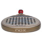 The top of a gold Nox Future padel racket on a white background.