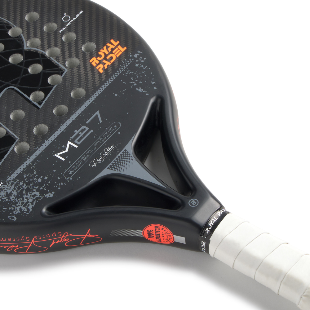 Close up of a black Royal Padel padel racket with orange branding on a white background.