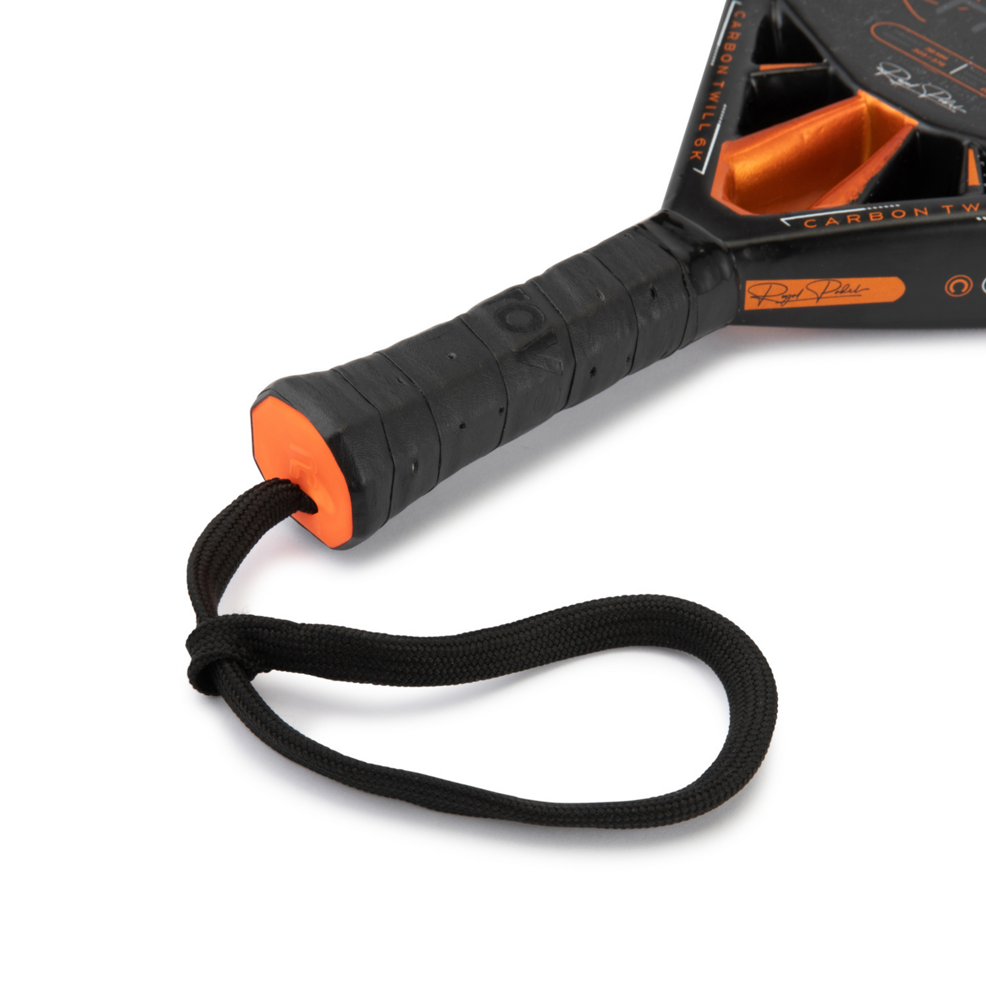 Close-up of a Royal Paddle R Limited Edition paddle racket with a black handle and orange accent on a white background