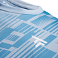 Close-up of a blue sports t-shirt with geometric pattern and white logo
