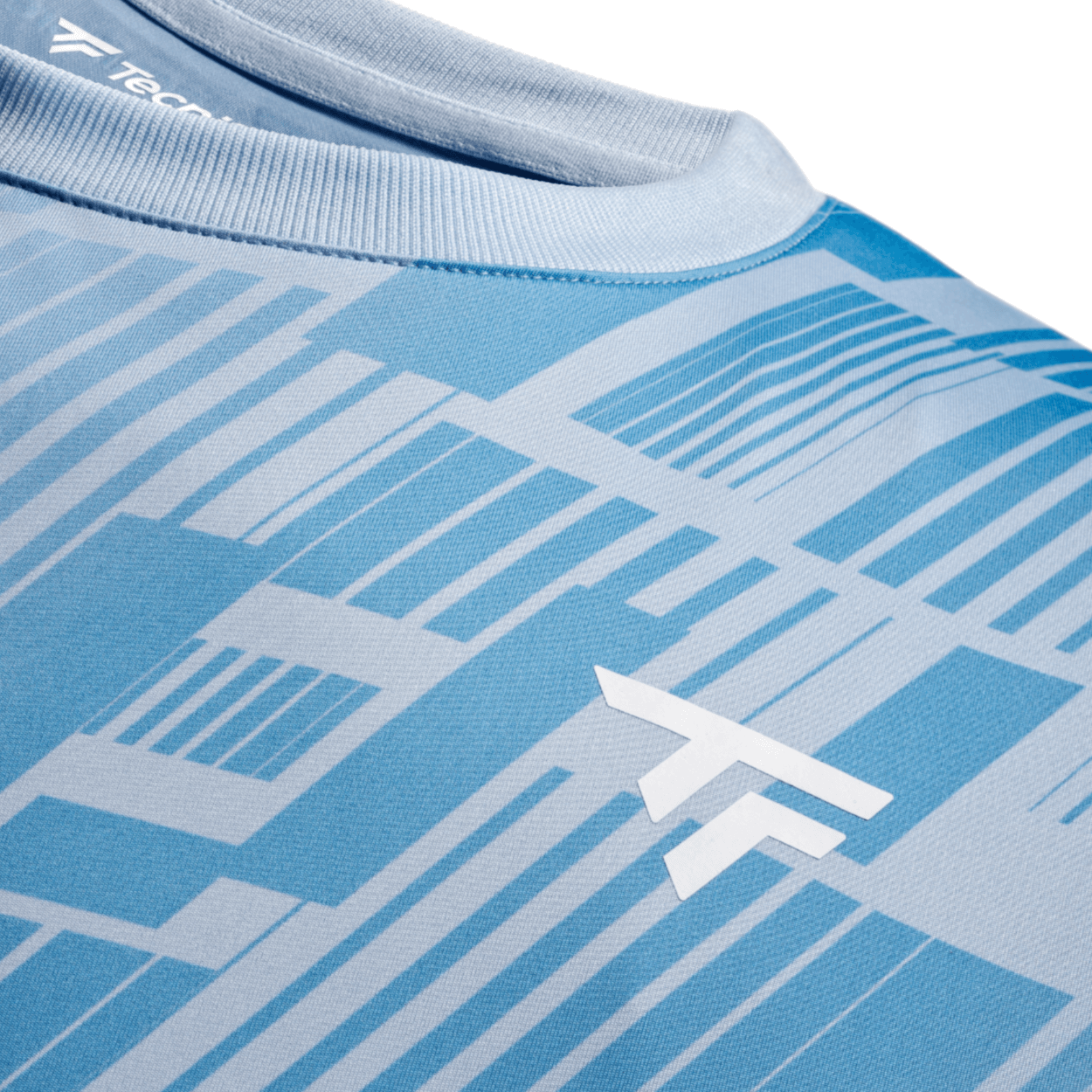 Close-up of a blue sports t-shirt with geometric pattern and white logo