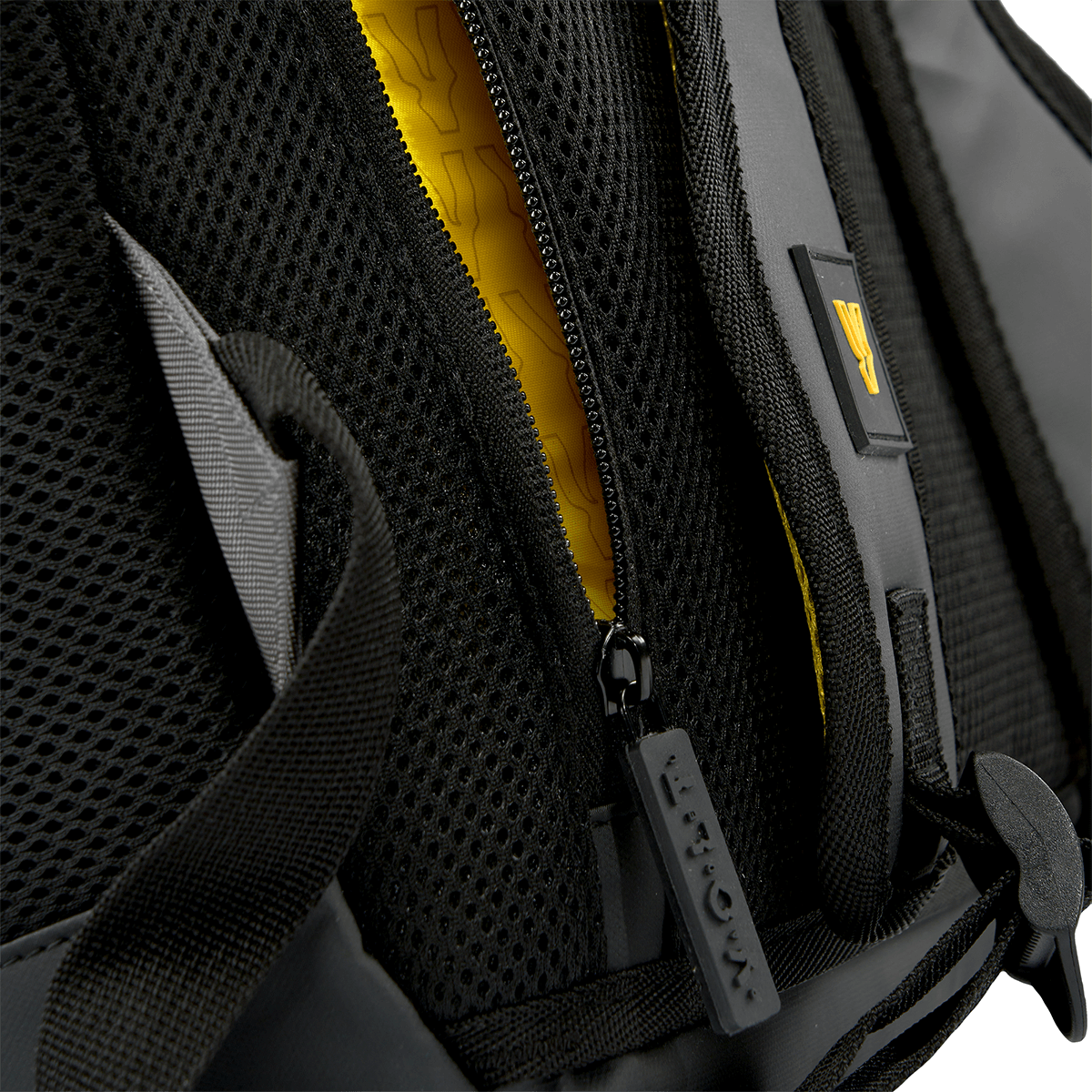 Close up of a grey Volt padel backpack, showing the zip and yellow detail