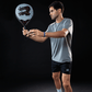 Man holding a blue padel racket with Royal Padel branding in a serve position with a black background