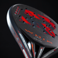 Close-up of a black and red Royal Padel racket with branding on a dark background