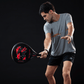 Man swinging a red and black Royal Padel padel tennis racket with Whip Extreme branding.