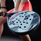 Close-up of a Royal Padel racket held by a person, with a dark background